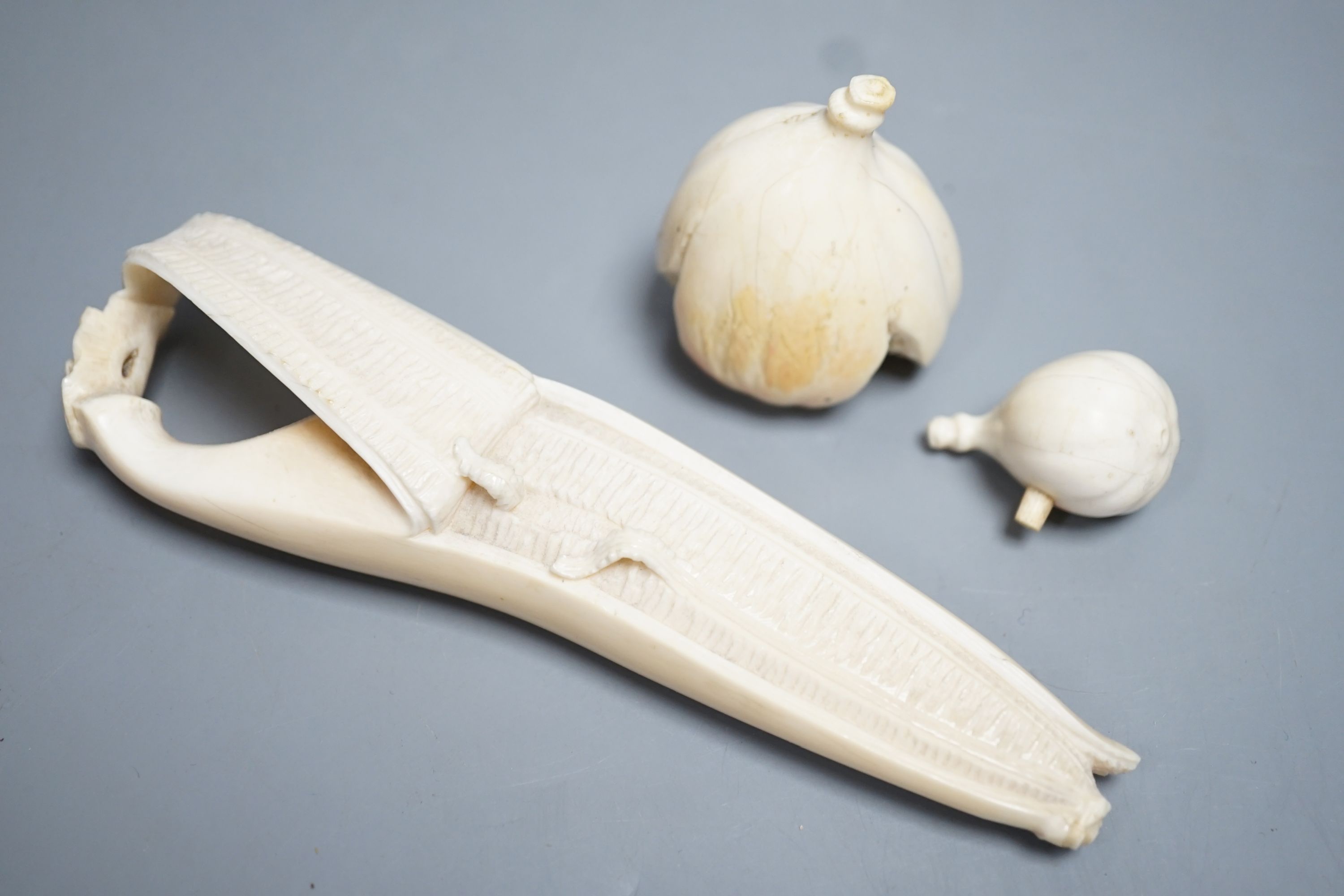 A Japanese ivory model of a partially peeled banana and an ivory model of figs, early 20th century (2) 15.5cm